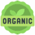 A green circular seal with a scalloped edge featuring two leaves and the bold text "ORGANIC"