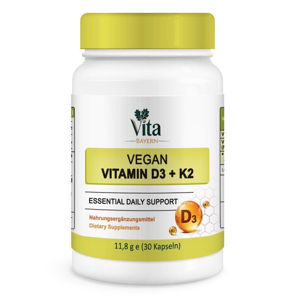 Eine weiße Flasche mit 30 Kapseln Vita Elixia Vegan Vitamin D3 + K2 "Essential Daily Support" mit goldenen D3- und K2-Nährstoffkugeln